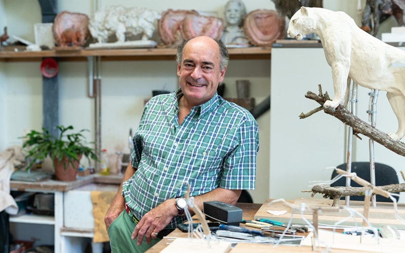 Mark posing with one of his sculptures