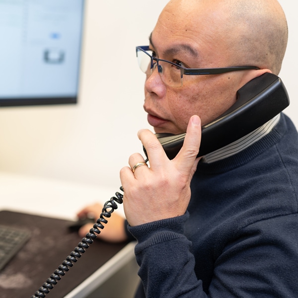 An IT technician speaks to a supplier over the phone